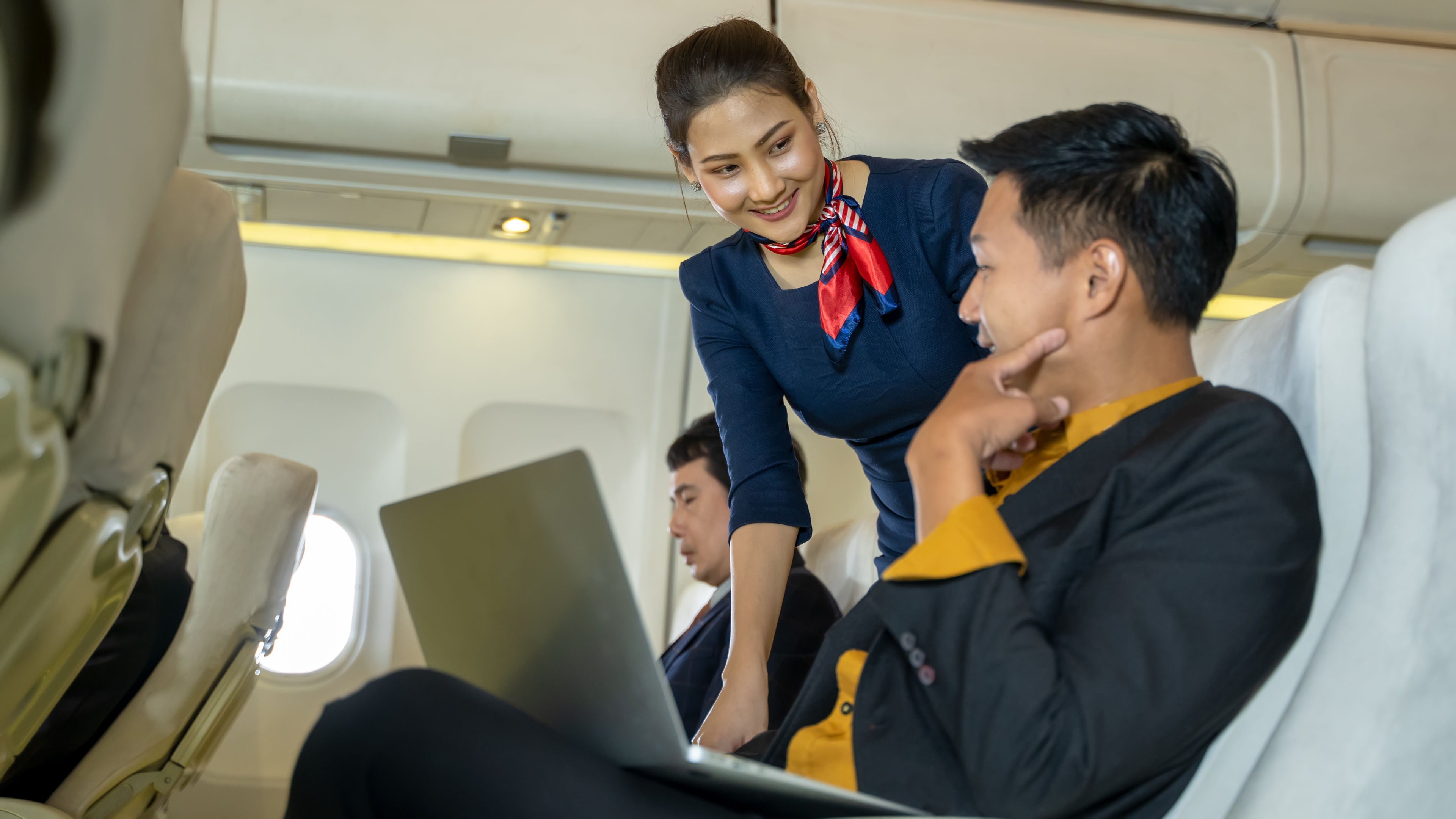 Air hostess takes care of passengers in planes flight attendants serve on board
