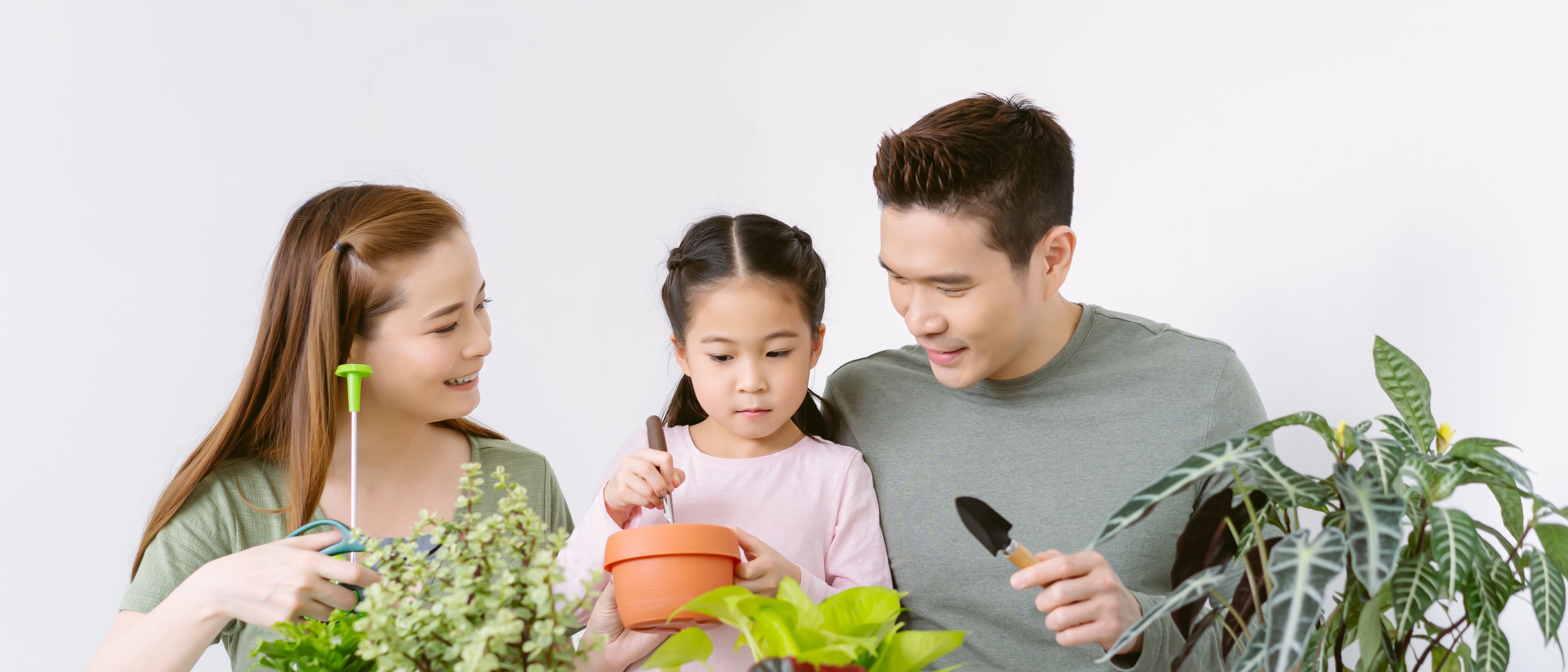 Family tending to potted plants.