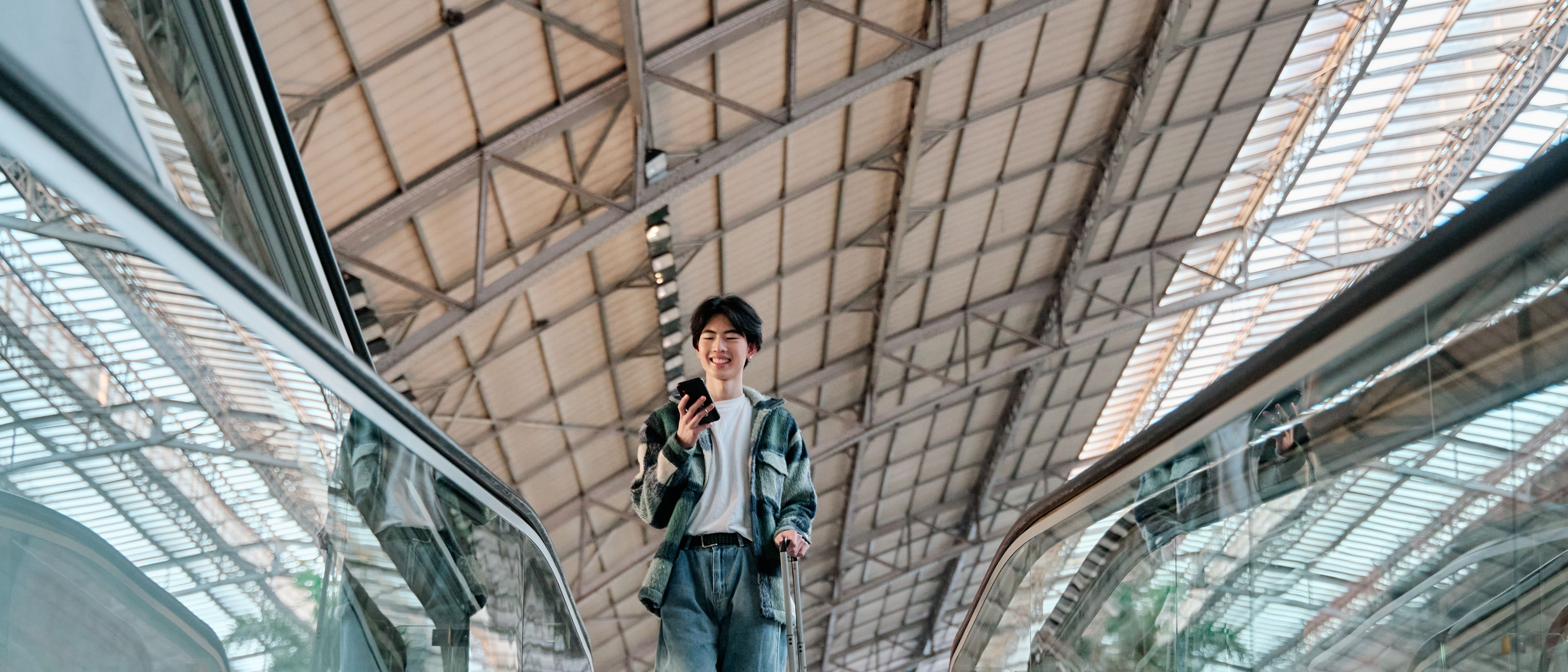 Young traveler on an escalator.